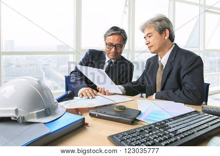 partner of senior engineering working man serious meeting about project dicussing solution shot on table in office meeting room