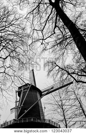 Typical Dutch windmill, black and white, in winter time
