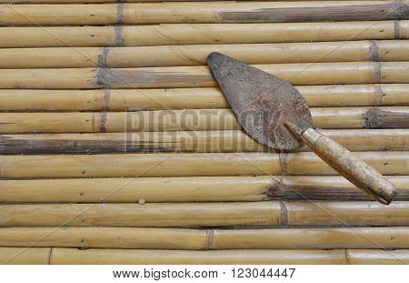 old steel trowel on the bamboo table