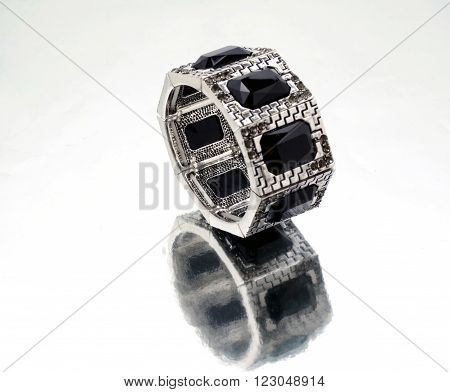 Silver bracelet with black gems on mirrorlike background