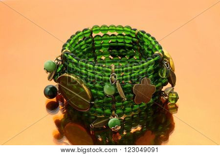Oriental beads bracelet on ...... mirrorlike background