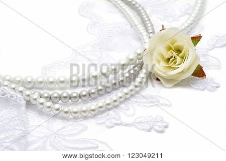 Pearl beads strings on white lace with flowerish tracery