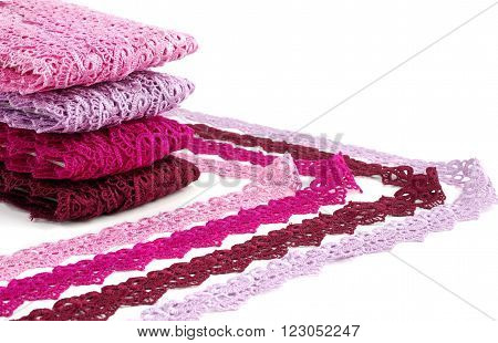 Reddish lace stretched over white background - pink, wine, raspberry-red