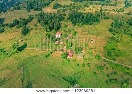 Small mountain houses on the plateau on the mountain in Montenegro on the sunny summer morning.