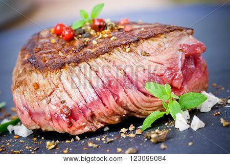medium grilled steak with thyme close up