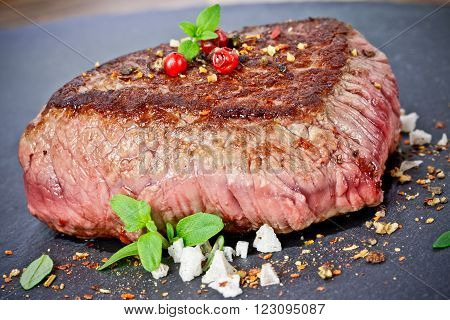 medium grilled steak with thyme close up