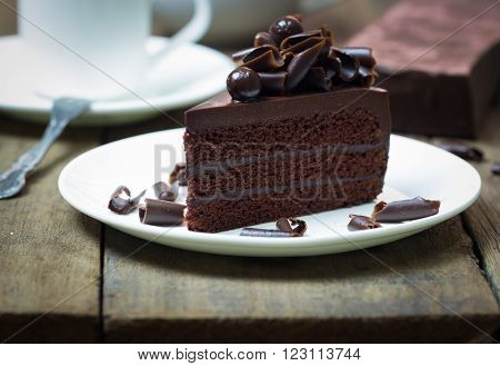 Chocolate Cake Topping With Chocolate Curl On Wood Background