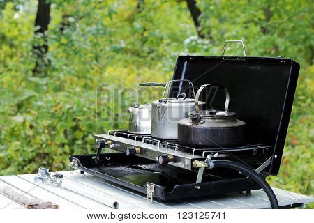 close-up camping kettles on the stove in the forest