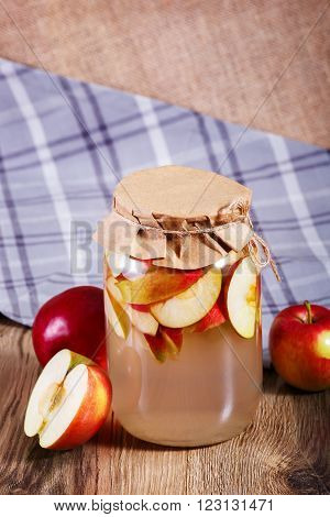 Sweet Delicious Compote Of Apples In Glass Jar On Wooden Table.