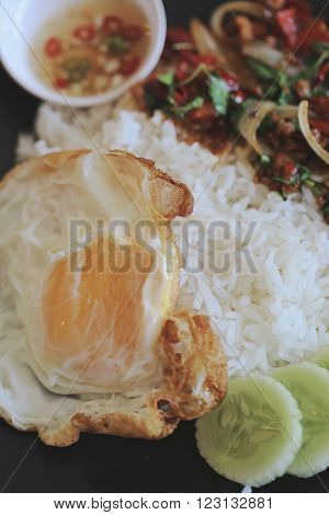 Thai stir-fried pork and basil served with rice and fried egg / Pad kra Prao