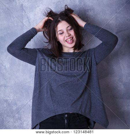 Teen Girl In Studio Posing On A Dark Background