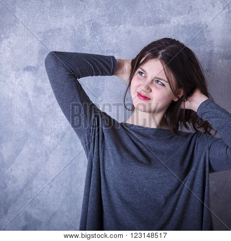 Teen Girl In Studio Posing On A Dark Background