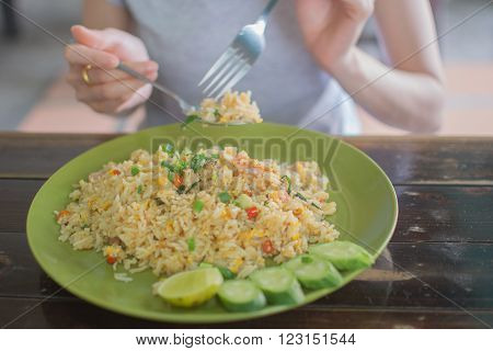 a girl eating Fried rice on soft focus