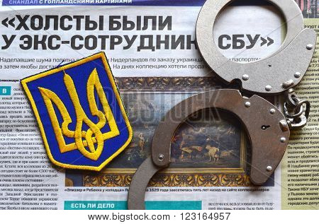 Kiev,Ukraine.FEB 20.ILLUSTRATIVE EDITORIAL.Chevron Ukrainian nazionalist battalion.Background - newspaper about West Frisian stolen art . February 20,2016 in Kiev, Ukraine