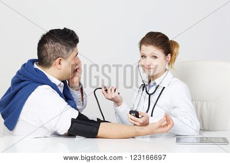 beautiful young woman Doctor checking patient pressure