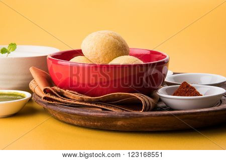 dahi vada or dahi vade also known as Curd Vadai in South India, a popular snack famous all over India prepared by soaking lentil vadas in thick dahi or yogurt, topped with spicy & sweet chutney etc