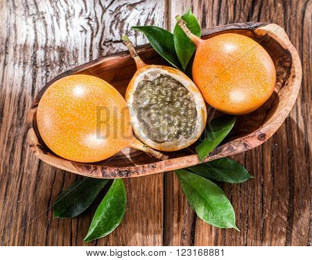 Granadilla fruits on the wooden table.
