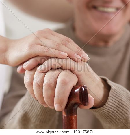 Young helpful carer and happy old man