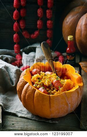stew from pumpkin with salami sausages in the whole pumpkin