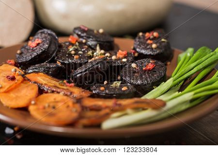 macro image of black pudding sausage with spices on a cutting board
** Note: Shallow depth of field