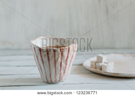 Tea and Turkish delight pottery handmade cup of tea on a white background