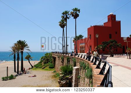 BENALMADENA, SPAIN - JUNE 2, 2008 - View of Bil Bil castle (Castillo Bil Bil) along the promenade with tourists on the beach Benalmadena Costa del Sol Malaga Province Andalusia Spain Western Europe, June 2, 2008.