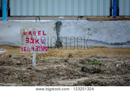 BAKU - AZERBAIJAN - JANUARY 16 2015
35kV warning sign in construction sign in Baku, capital of Azerbaijan. A hand painted sign on a building site, advising of high voltage cable