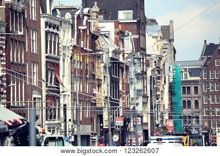 AMSTERDAM THE NETHERLANDS - AUGUST 19 2015: Rokin street with row of shops; restaurants and Dam Square. Amsterdam is capital of the Netherlands on August 19 2015.