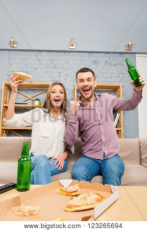 Two Football Fans Watching Tv With Beer And Pizza