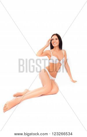 Cheerful Slim Woman Sitting In Lingerie On White Background