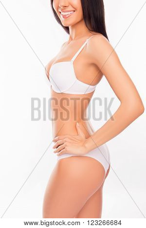 Side View Photo Of Cheerful Smiling Young Woman In White Lingerie
