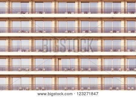 Windows and balconies of the hotel at sunset time.