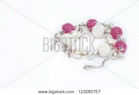 Pink and white beaded bracelets on  the white
** Note: Shallow depth of field