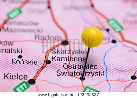 Photo of pinned Ostrowiec Swietokrzyski on a map of Poland. May be used as illustration for traveling theme.