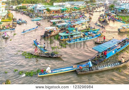 Soc Trang, Vietnam - February 3rd, 2016: Scenes trade agricultural products in morning floating market with boatload full concentrated rotation rhythm intersection in filthy rivers characteristic wetland sale in Soc Trang, Vietnam