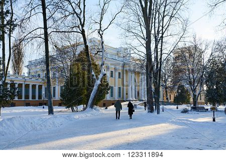 GOMEL BELARUS - JANUARY 17 2016: Unidentified people walk in a winter snow-covered park near the Palace of Rumyantsev-Paskevich Gomel Belarus