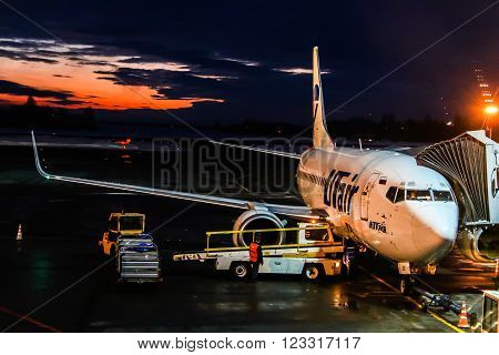 UFA RUSSIA - FEBRUARY 18 2016: UTair Boeing 737 is boarded in the Ufa International Airport at the background of the sunset.