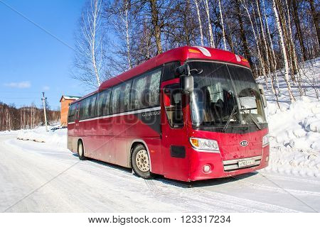 ASHA, RUSSIA - FEBRUARY 21, 2016: Red intercity coach Kia Granbird at the countryside.