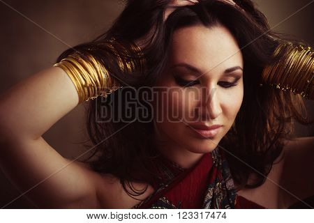 Indian woman with gold bracelets on hands. Traditional east accessories on  indian woman. Foto of indian girl in east style.