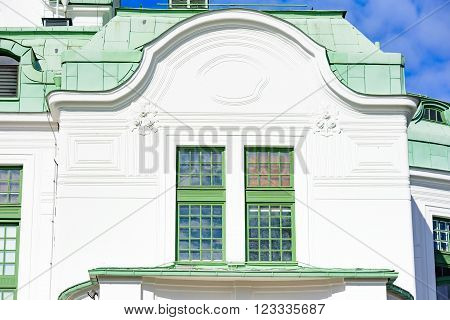 Kristianstad Sweden - March 20 2016: Architectural detail of the Theater in town. This is a window at the backside of the building. Green copper patina on the roof.