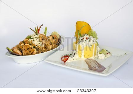 Peruvian Food: Causa Rellena, A smashed popatoes filled with crab meal and Rice with sea food. 2 dishes served as a main meal