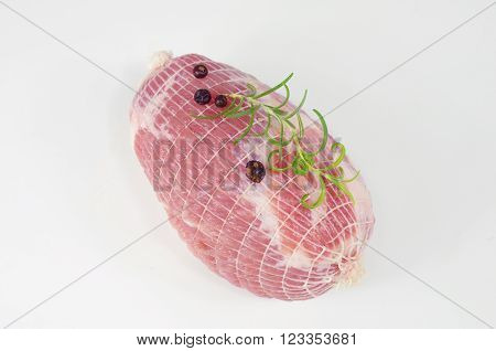 raw ham with rosemary and laurel on plate
