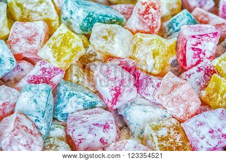 Turkish sweets lukum colored background. Estern delicatessen