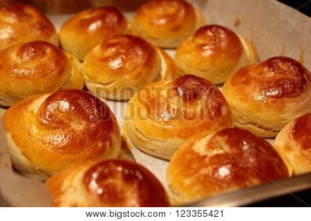 Snail shaped bread rolls in a baking sheet