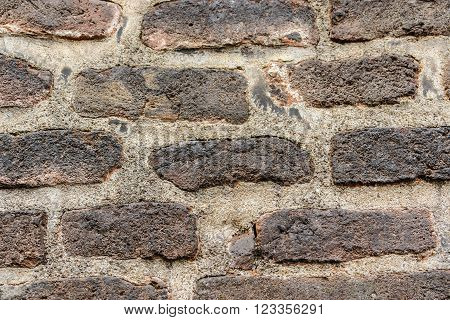 A dark brick wall background texture ,close-up outdoors