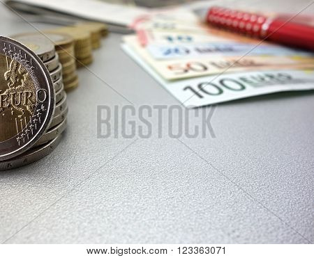 euro banknotes and coins on a gray background