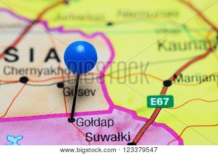 Photo of pinned Goldap on a map of Poland. May be used as illustration for traveling theme.