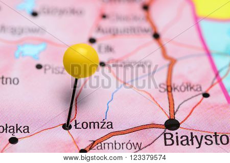 Photo of pinned Lomza on a map of Poland. May be used as illustration for traveling theme.