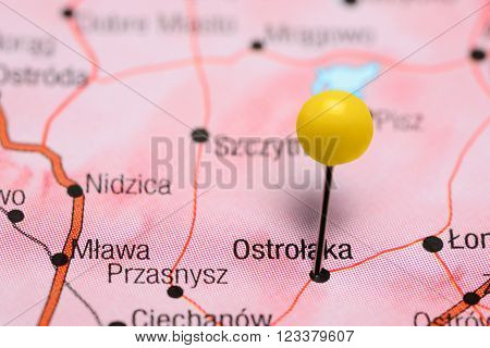 Photo of pinned Ostroleka on a map of Poland. May be used as illustration for traveling theme.