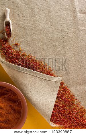 Dried saffron spice on a linen napkin and ground saffron